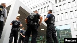 German police officers stand guard outside the hospital in Berlin where Russian opposition leader Aleksei Navalny is receiving medical treatment. 