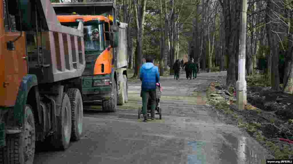 Люди прогулюються поруч із КамАЗами