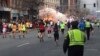 Runners continue to run towards the finish line of the Boston Marathon as an explosion erupts near the finish line of the race in this photo exclusively licensed to Reuters by photographer Dan Lampariello after he took the photo in Boston, Massachusetts, 