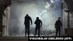 KYRGYZSTAN -- Protesters run away from tear gas during clashes with riot police during a rally against the results of a parliamentary vote in Bishkek on October 5, 2020. 