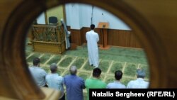 MOLDOVA, CHISINAU - Muslim men praying in a Moldovan mosque